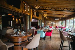 a restaurant with tables and chairs in a room at Hotel & Restaurant Carevoselski in Delčevo