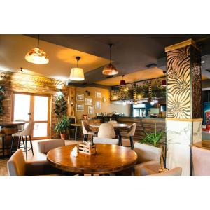a restaurant with tables and chairs and a bar at Hotel & Restaurant Carevoselski in Delčevo +13 photos