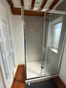 a glass shower in a room with a ceiling at La maisonnette in Coulombs