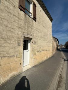 a shadow of a person standing in front of a building at La maisonnette in Coulombs