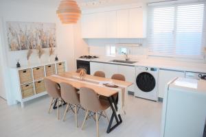a kitchen with a wooden table and chairs at RoseBrickHouse in Gwangju