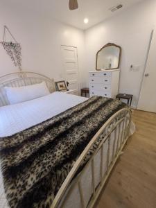 a bedroom with a bed and a dresser and a mirror at Casa Dorado - Bright, Sunny 2 Bedroom 1 Bath House - Fenced Yard, Private Patio in Santa Barbara