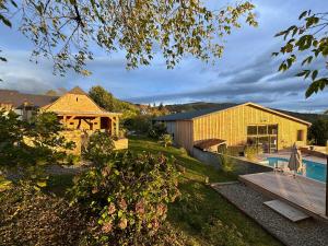 a backyard with a pool and a house at Domaine Aari Ona in Aramits