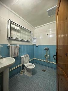 a bathroom with a toilet and a sink at Appartement champs élyséen in Berkane +35 photos
