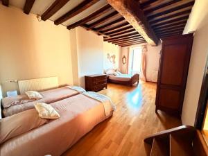 a large bedroom with two beds and a couch at gîte Chez Joëlle in Les Riceys