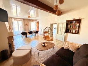 a living room with a couch and a table at gîte Chez Joëlle in Les Riceys