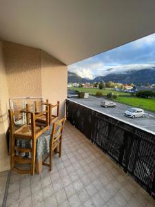 a balcony with two chairs and a view of a road at Paisible studio fonctionnel in Cluses