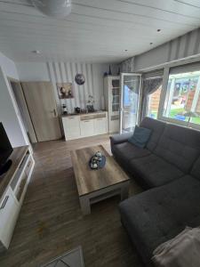 a living room with a couch and a coffee table at FeWo zwischen den Deichen in Emden