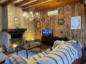a living room with a couch and a fireplace at La grange du Ruet in Saint-Hilaire-Saint-Mesmin