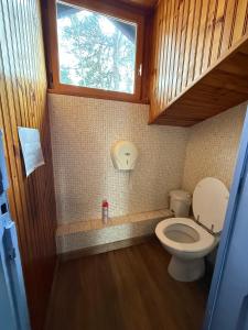 a small bathroom with a toilet and a window at Matsya Hostel in Anglet +43 photos