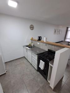 a kitchen with a stove and a counter top at Deptosuno in General Roca