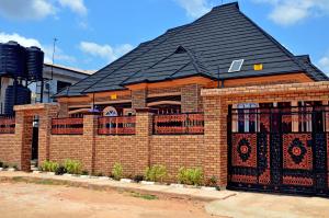 a brick house with a black roof at New Benin Home in Benin City