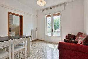 a living room with a table and a red couch at Cozy Best Appartment in Marghera