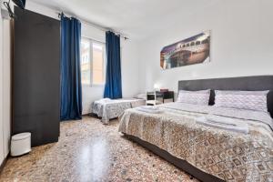 a bedroom with a large bed and blue curtains at Cozy Best Appartment in Marghera