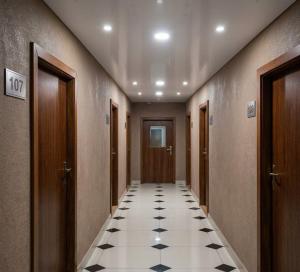 a hallway with a tile floor in a building at Panorama H2O Self Check-in Pool in Korosten +4 photos