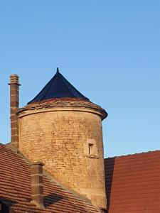a brick tower on the roof of a building at gîte Chez Joëlle in Les Riceys