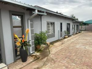 a building with a vase of flowers on the side of it at The Wentworth Guest House in Krugersdorp