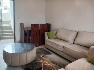 a living room with a couch and a coffee table at Buxton Point Classy 3BR in Mombasa
