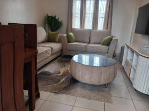 a living room with a couch and a coffee table at Buxton Point Classy 3BR in Mombasa