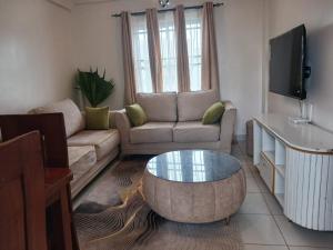 a living room with a couch and a coffee table at Buxton Point Classy 3BR in Mombasa