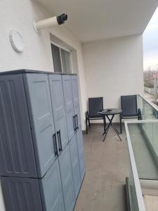 a room with lockers and a table in a building at Apartment White Tower Residential in Ploieşti