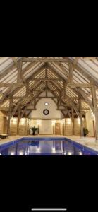 a building with a wooden ceiling with a swimming pool at par 3 in Wisbech