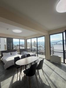 a bedroom with a bed and a table and chairs at Natali Apart-hotel in Tbilisi City