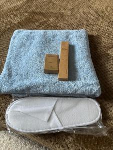 a wallet and a tag on a blue towel at Athens Air B&B in Athens +20 photos