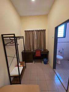 a room with a bathroom with a desk and a toilet at KRS Pines GuestHouse in Cameron Highlands +67 photos