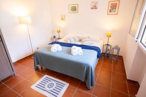 a bedroom with a bed with towels on it at SeaSide Paradise - Seafront Terrace Apartment by BariHouses in Cozze