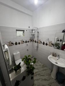 a bathroom with a toilet and a sink at Kandy Green Nature Villa in Kandy +21 photos