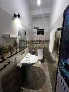 a bathroom with a white sink and a toilet at Kandy Green Nature Villa in Kandy