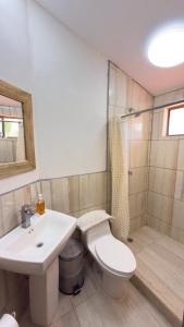 a bathroom with a toilet and a sink and a shower at Casa la barra surf resort in Miramar