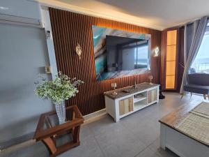 a living room with a large painting on the wall at Flat 108 Cozumel, Umdloti Beach Front in Umdloti