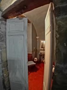 an open door to a room with a table at La Casa Rosa in Pigna +42 photos