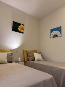 a room with two beds and a couch at Alba in Fiore in Alba