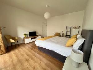 a bedroom with a bed and a desk with a television at Martins' Happy Home in Coimbra