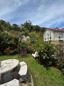 a park with a picnic table and a playground at KRS Pines GuestHouse in Cameron Highlands