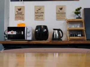 a counter with a coffee maker and a microwave at 333 MiNi House in Chiang Mai