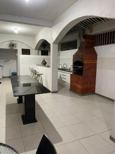 a kitchen with a glass table in a room at Pousada Mirante do Sol in Piúma