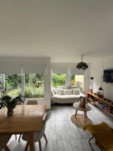 a living room with a couch and a table at Casa Boutique de la Sierra in Sierra de los Padres
