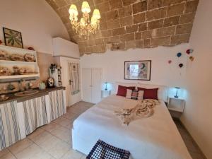 a bedroom with a large white bed in a room at La Chicca di Fiore - Guest House in Gallipoli