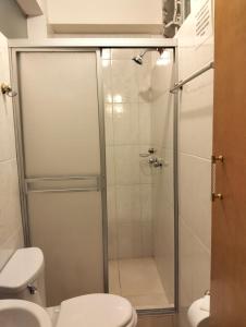a bathroom with a shower and a toilet at Killitas home&apart in Cusco