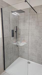 a shower with a glass door in a bathroom at 215 addaura luxury room in Palermo