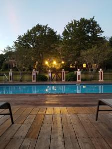 a wooden deck with a pool at night at Inn at Lake Joseph in Forestburgh