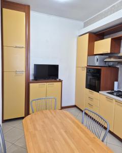 a kitchen with a table and chairs in a room at Punto Zero Ca' Trillina in La Spezia +3 photos