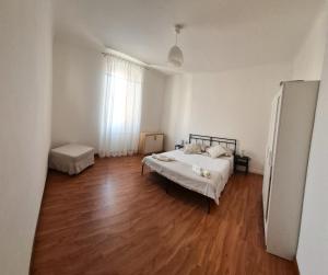 a bedroom with a bed and a wooden floor at Punto Zero Ca' Trillina in La Spezia