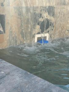 a water fountain in a pool of water at Ou Souleou appartement 3 étoiles dans villa Spa béton jardin vue mer et colline in Bormes-les-Mimosas