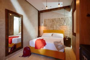 a bedroom with a large mirror and a bed at Mamaco Trani Homey in Trani