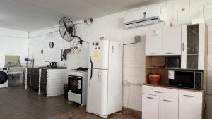 a kitchen with a refrigerator and a stove at brisas del dique in San Fernando del Valle de Catamarca